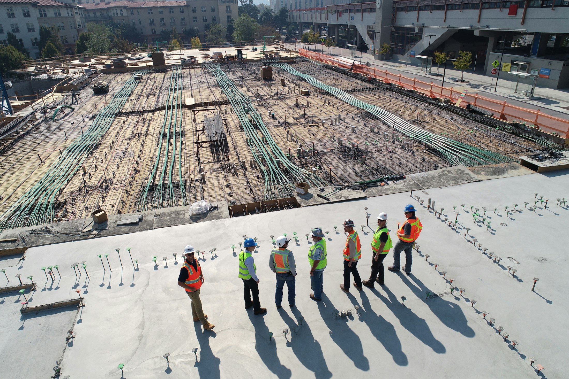A project team walking a concrete deck on an active urban jobsite